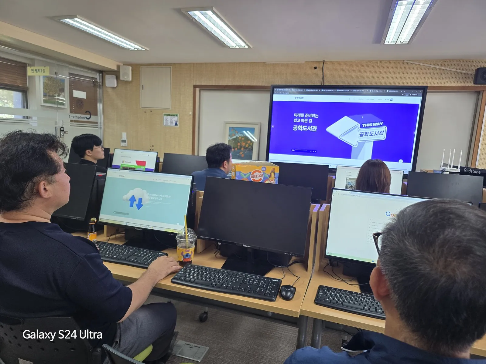 컴퓨터실에서 공학도서관 플랫폼 연수를 받는 교사들